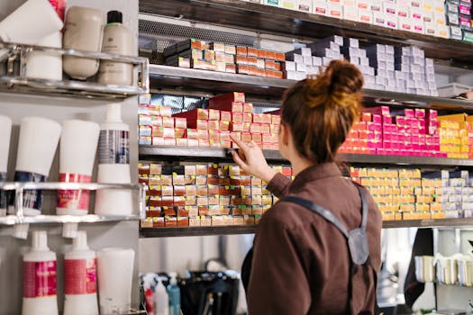 A stylist applying hair dye with a vibrant backdrop